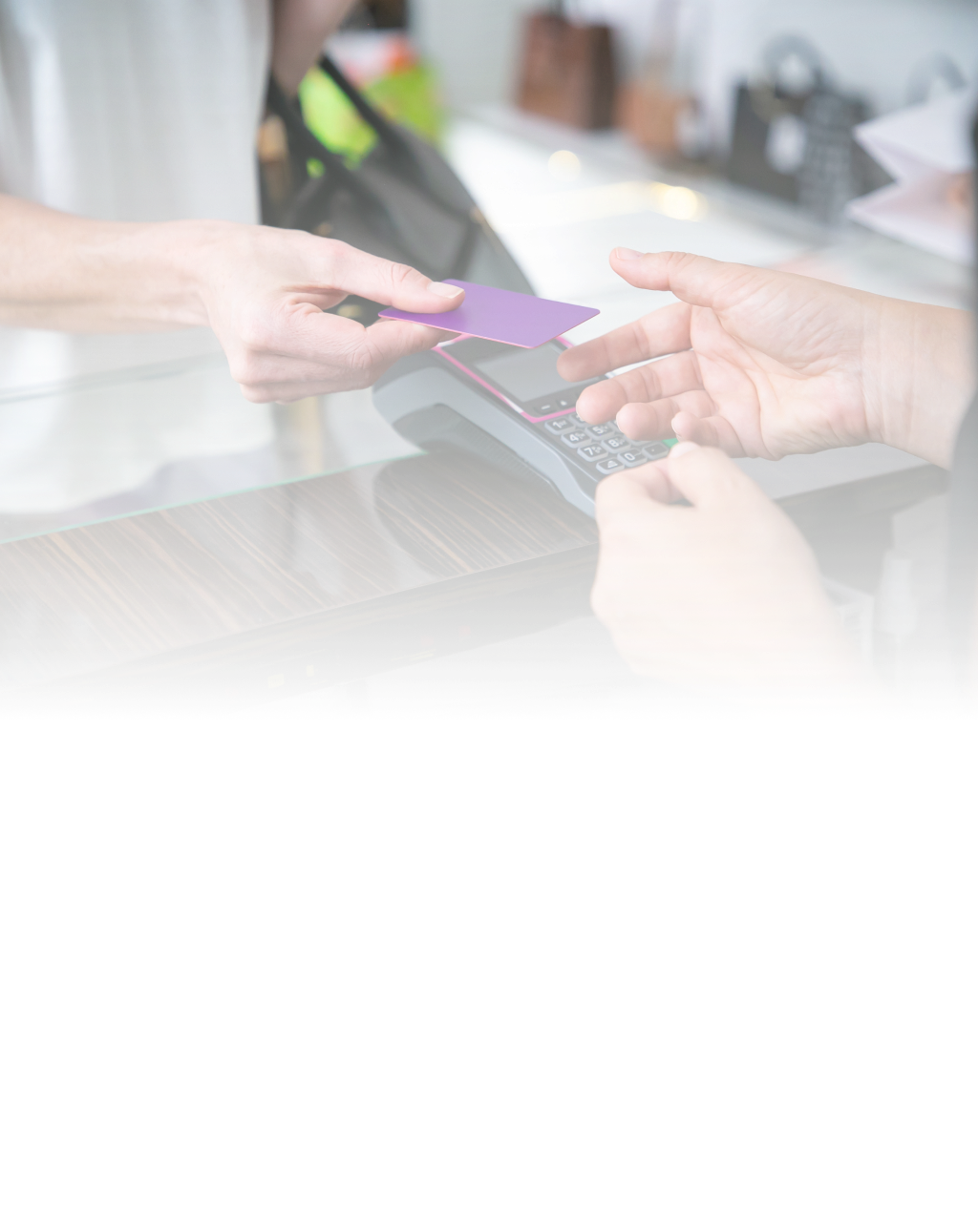 a customer using a payment gateway to pay for their shopping in a store