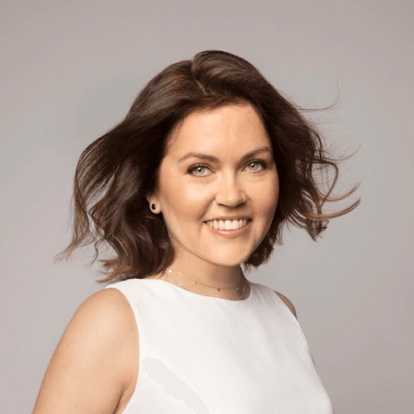 A woman with short hair wearing a white dress