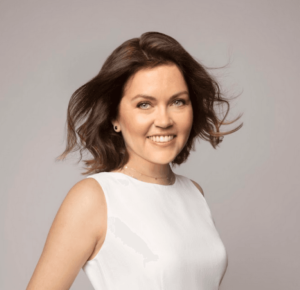 A woman with short hair wearing a white dress