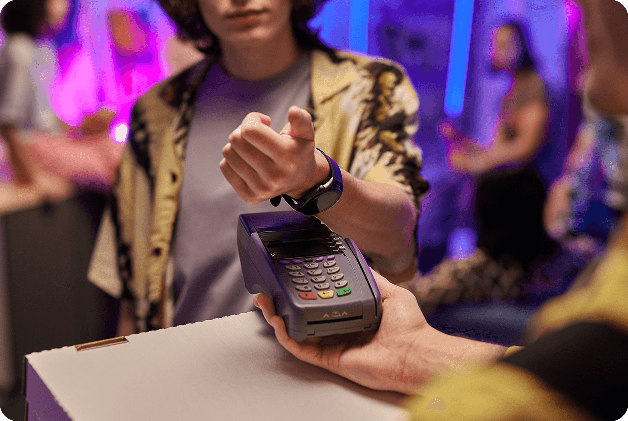 A young person is paying by his smartwatch