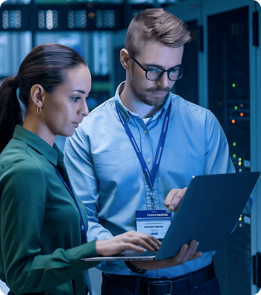 a man with a badge and woman are looking at the laptop