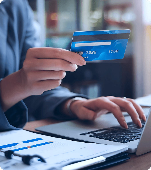 a person is paying by her credit card for online shopping
