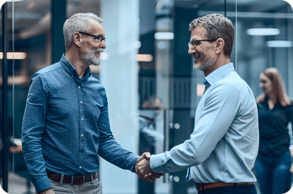 Two middle age persons shaking hands