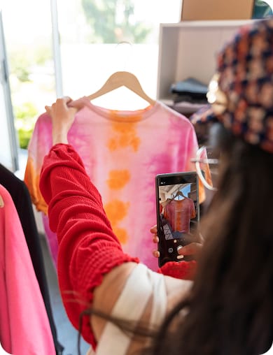 woman taking picture of clothes
