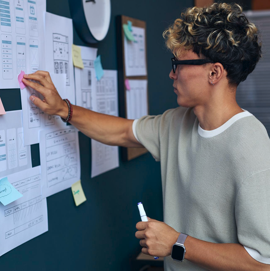A man next to the memo board