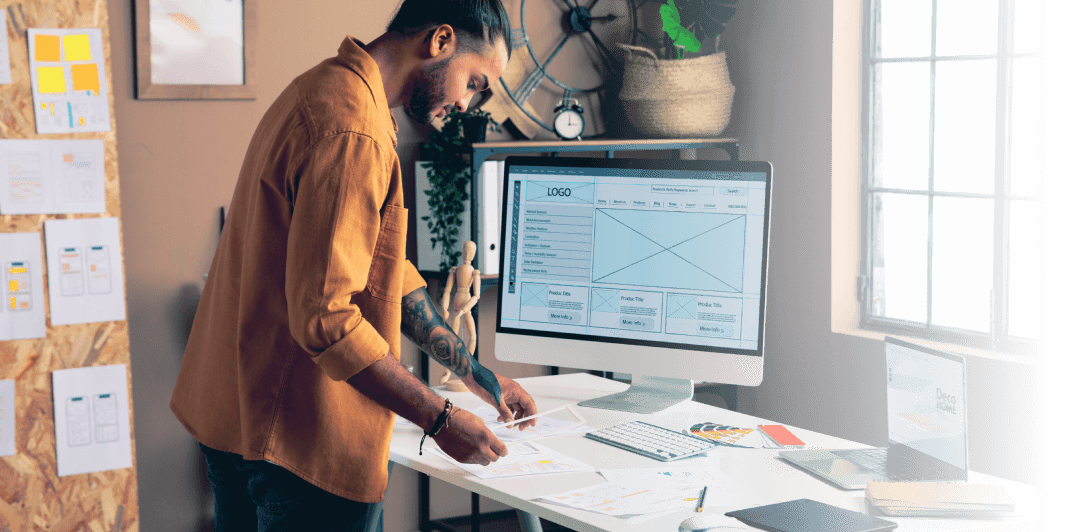 A man standing at the desk and building a custom web application