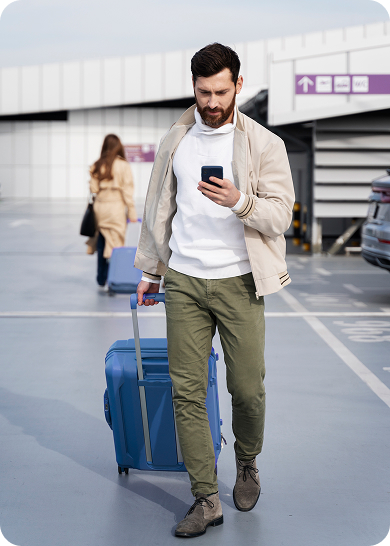 A man in front of an airport